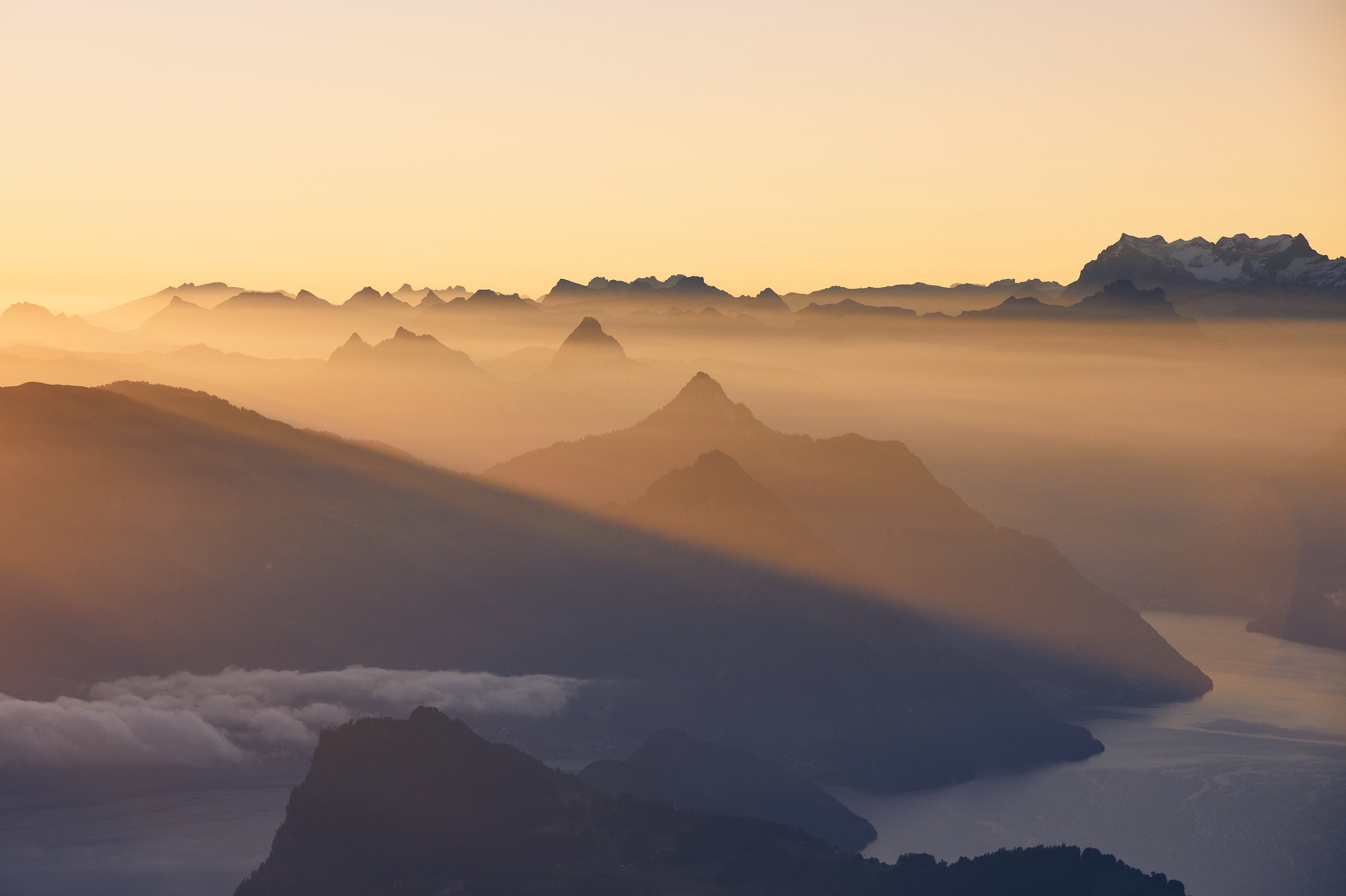 scenic-view-of-lake-and-mountains-at-sunrise